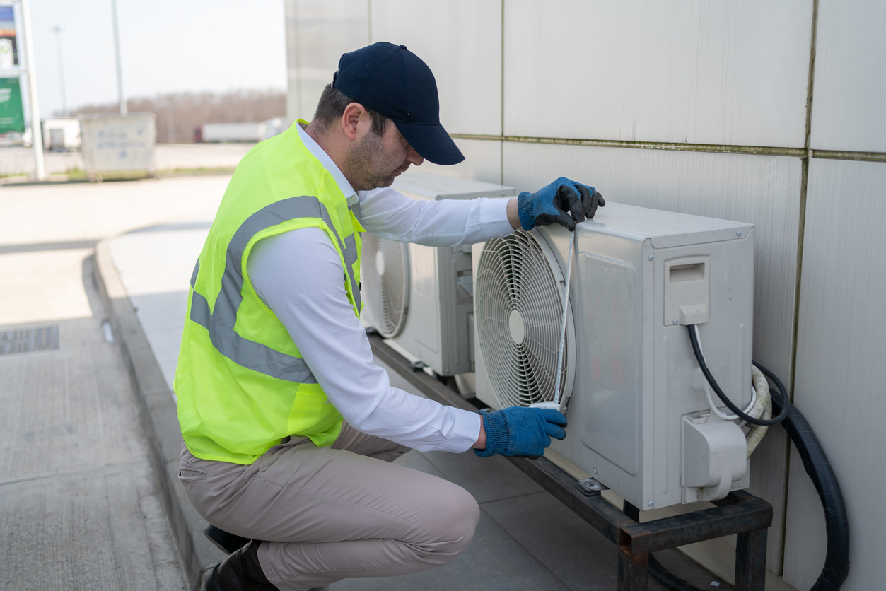 Man Servicing Outdoor Air Conditioning Unit